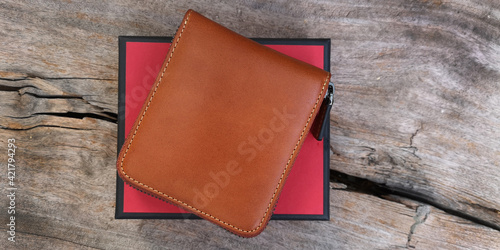 a leather wallet on grungy wood