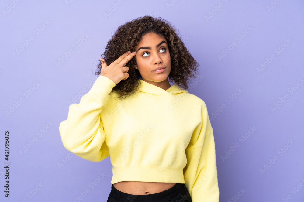 Young African American woman isolated on background with problems making suicide gesture Young African American woman isolated on background with problems making suicide gesture