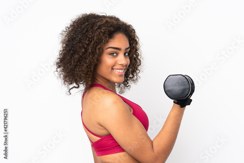 Young African American sport woman isolated on white background making weightlifting