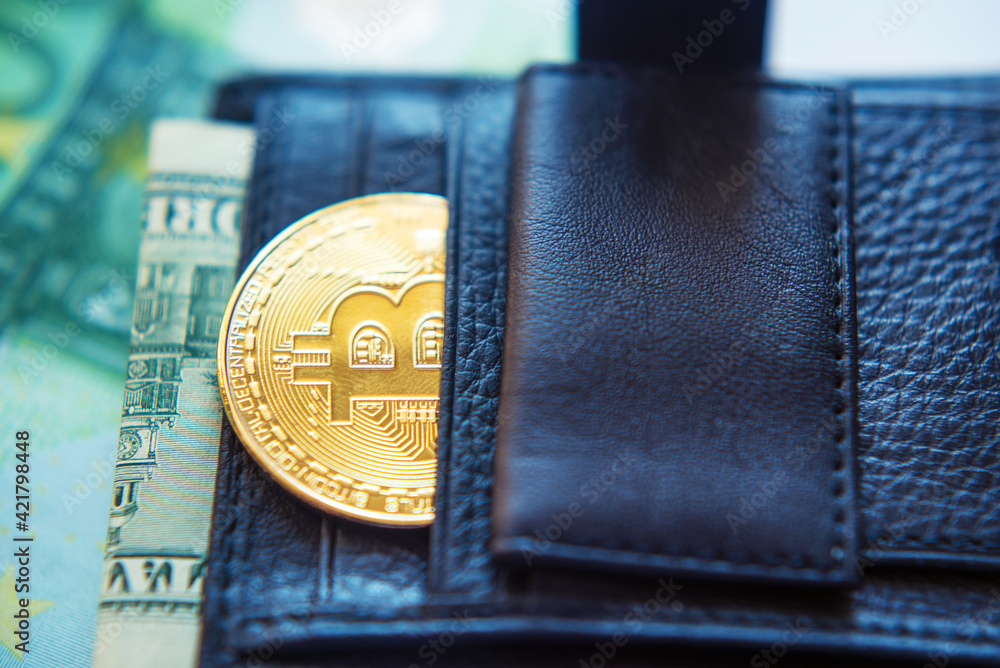 bitcoins and a dollar bill in a leather black wallet (Investment, exchange rate, rise, decline, luxury, success, stock exchange - concept)