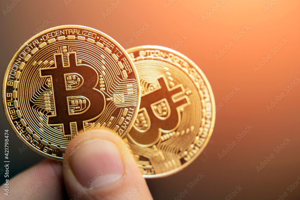 two bitcoins in hand (Investment, course change, rise, decline, luxury, success, stock exchange - concept)