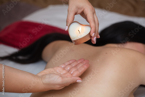 massage with aroma candle in spa salon