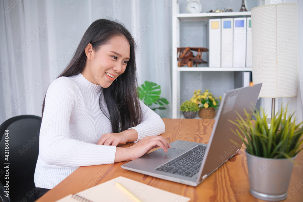 Young Asian female college student studying online class video call conference tutorial, using computer laptop browsing internet online education learning, happy smiling home quarantine modern office Young Asian female college student studying online class video call conference tutorial, using computer laptop browsing internet online education learning, happy smiling home quarantine modern office