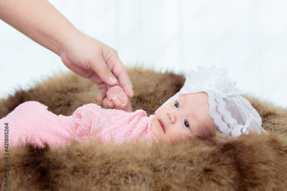0-1 month Asian newborn baby lie down on brown fur in studio, toddler infant open eye seeking some voice near her, baby open eye or wake up after long sleeping, infant wrap up with warm blanket 0-1 month Asian newborn baby lie down on brown fur in studio, toddler infant open eye seeking some voice near her, baby open eye or wake up after long sleeping, infant wrap up with warm blanket