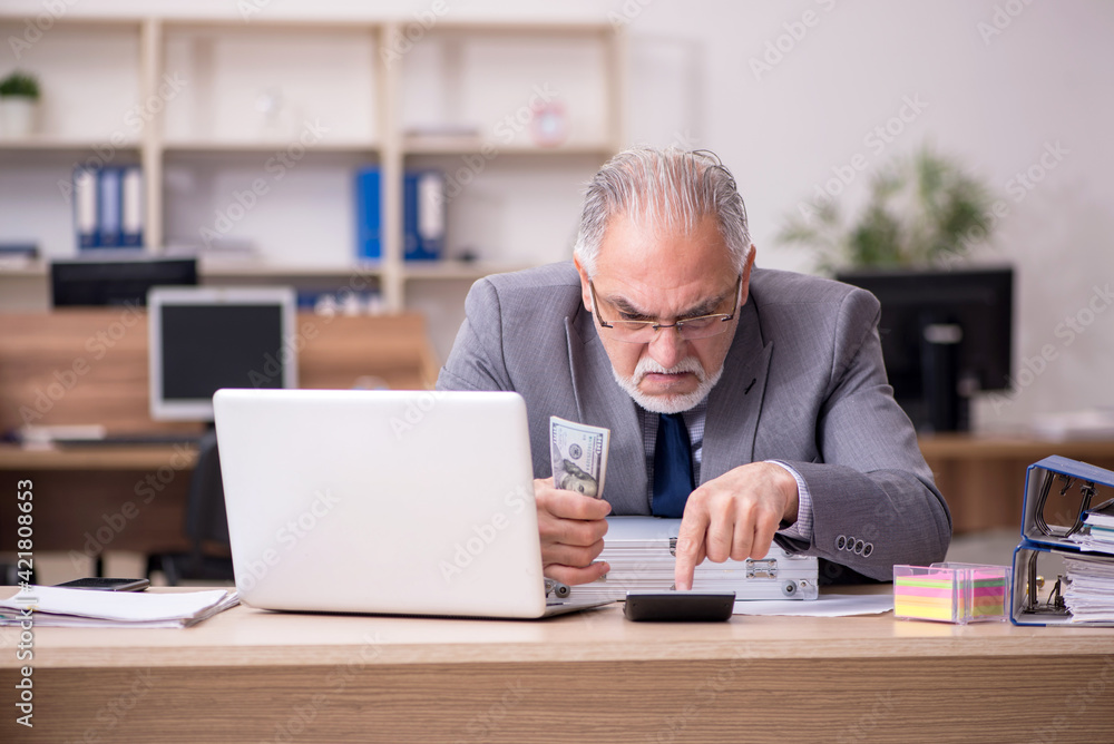 Old male employee in remuneration concept Old male employee in remuneration concept