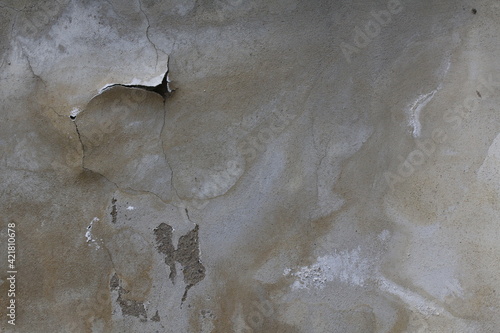 texture di un muro di cemento con parti rovinate e da intonacare  photo