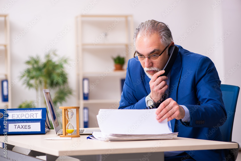 Old male employee businessman in time management concept Old male employee businessman in time management concept