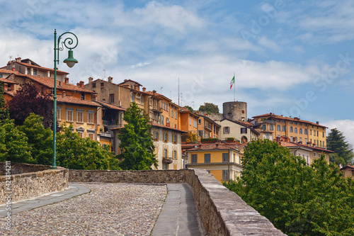 View of the old cobblestone road to Upper Bergamo (Citta Alta). Bergamo is a city in the alpine Lombardy region of northern Italy.