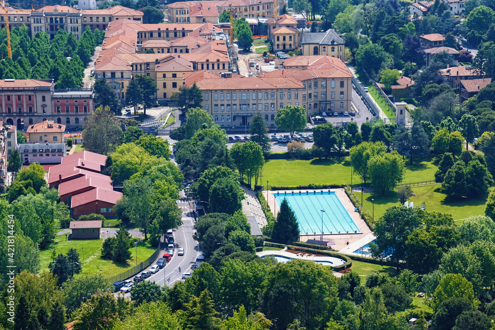 View of the historical buildings in the old town of Bergamo in northern Italy. With the swimming pool in the foreground. Bergamo is a city in the alpine Lombardy region. View of the historical buildings in the old town of Bergamo in northern Italy. With the swimming pool in the foreground. Bergamo is a city in the alpine Lombardy region.