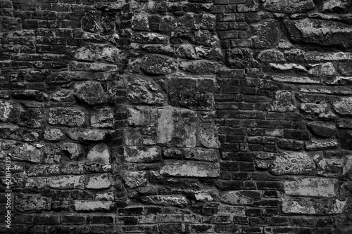 Old grungy retro grimy brick wall of ancient city. Uneven dirty pitted peeled surface brickwork of cellar worn. Ruined solid bumpy stiff blocks. Hard messy ragged holes brickwall for 3D grunge design