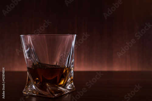 A glass of whiskey on the table
