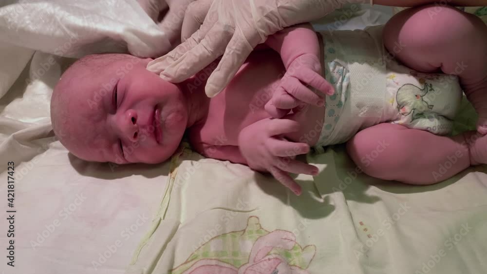 Newborn baby boy 15 minutes after birth on changing table in maternity hospital delivery room, infant during first day of life. Newborn baby boy 15 minutes after birth on changing table in maternity hospital delivery room, infant during first day of life.