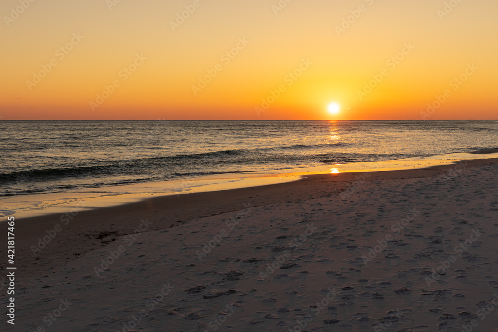 Beach sunset with a cloudless sky