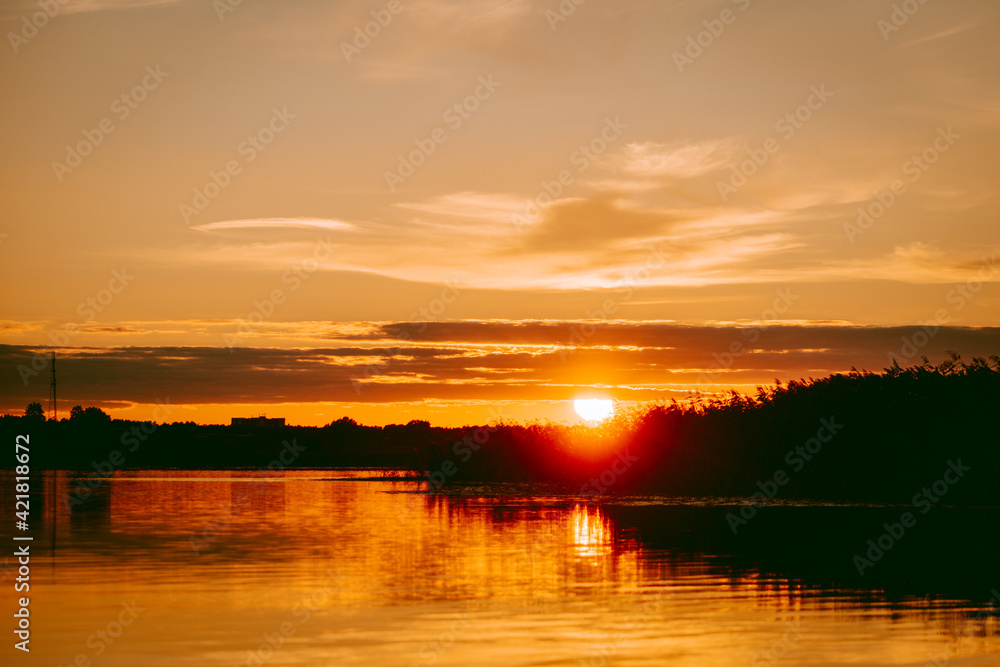 Colorful and intense sunset over the Lielupe river in Latvia during hot summer evening