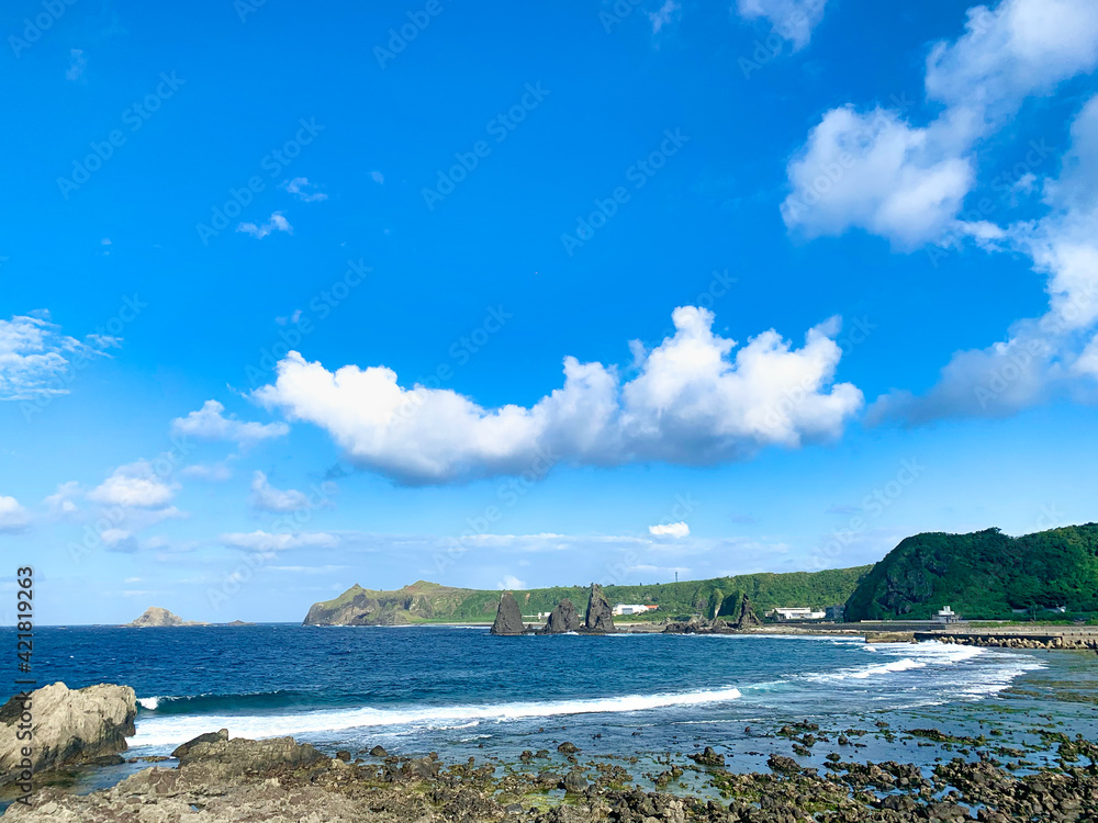 Rocky coastline photo of Green Island, Taiwan on a sunny day with turquoise ocean 