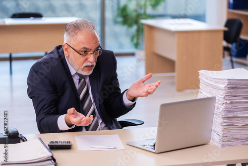 Aged businessman employee unhappy with excessive work