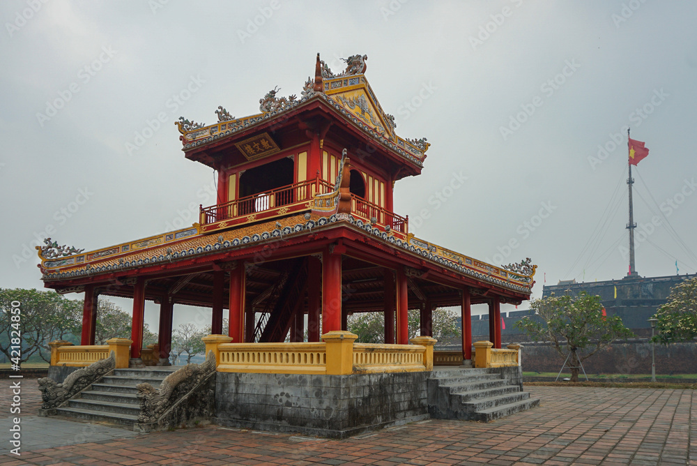 Colorful traditional pavilion with a flagpole in the background in Hue, Vietnam Colorful traditional pavilion with a flagpole in the background in Hue, Vietnam