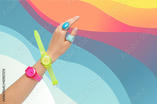 Female hand with stylish wrist watches on color background