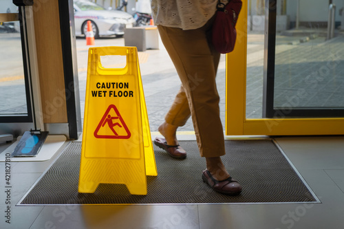 Yellow warning sign wet floor in shop.