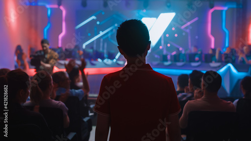 Esport Professional Gamer Enters Video Game Championship Arena. Cyber Games Tournament Event with Crowd of Fans and Spectators Cheering for Favourite Players. Online Streaming Entertainment