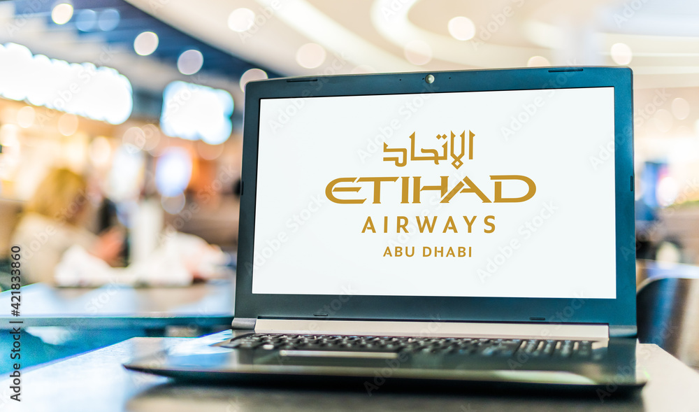 Laptop computer displaying logo of Etihad Airways Stock Photo Adobe Stock