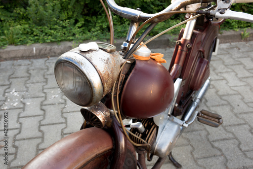 Old rusty lamp of a historical moped