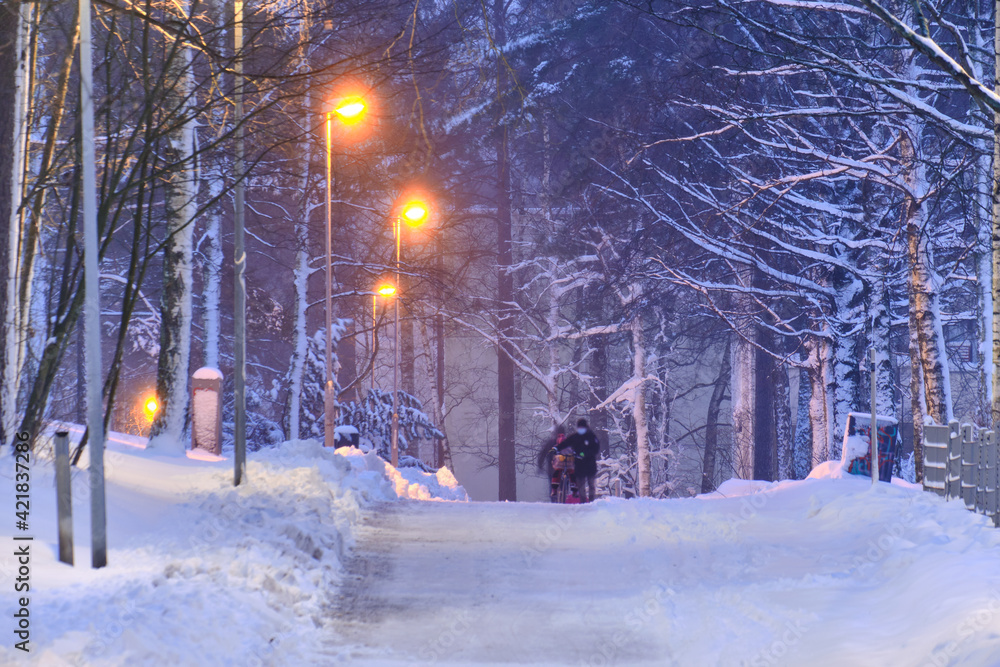 Snow-covered pedestrian street in the residential district after a snow-storm in the morning or evening in Finland.