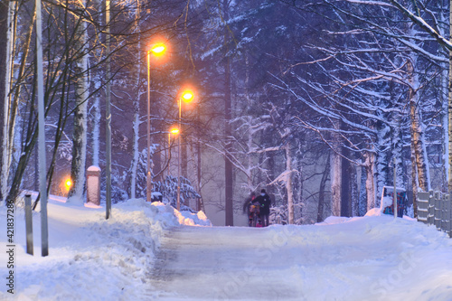 Obraz na płótnie Snow-covered pedestrian street in the residential district after a snow-storm in the morning or evening in Finland. w salonie