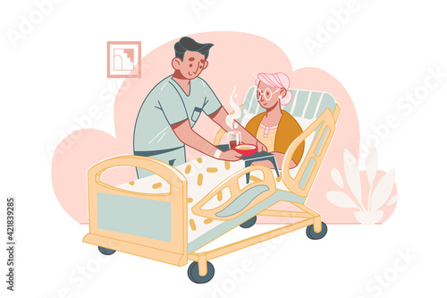 Elderly Care Concept. Social worker or volunteer takes care of and helps a bedridden elderly woman  with disabilities  in a nursing home. Assistance to senior people at home.