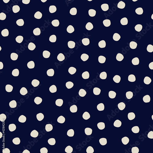 Seamless polka-dot pattern on dark blue background for surface design and other design projects