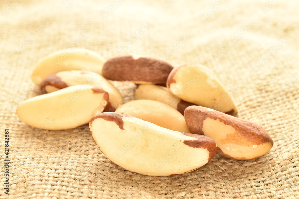 Several ripe organic Brazil nuts, close-up, on burlap. Several ripe organic Brazil nuts, close-up, on burlap.