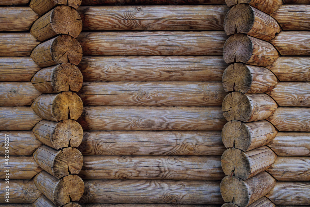 Dark unpainted wall of blockhouse. Log wall of wooden house. Round logs. Dark unpainted wall of blockhouse. Log wall of wooden house. Round logs.