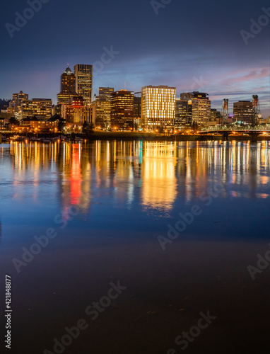 Looking west at the reflection of downtown Portland Oregon in the Willamette River at sunset
