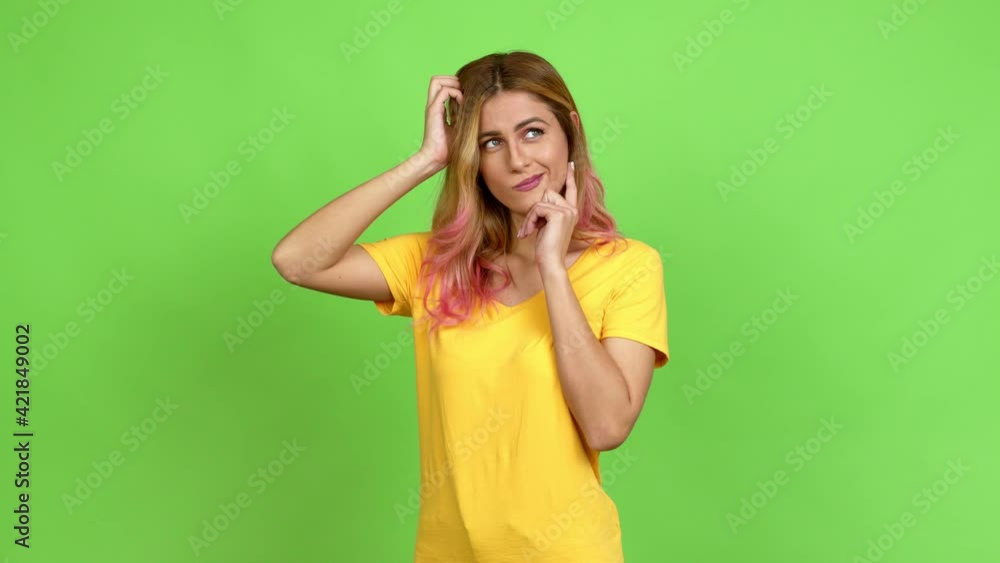 Young blonde woman having doubts while scratching head over isolated background on green screen chroma key Young blonde woman having doubts while scratching head over isolated background on green screen chroma key
