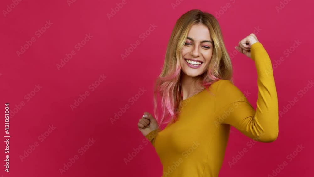 Young blonde woman celebrating a victory and surprised to be successful over isolated background Young blonde woman celebrating a victory and surprised to be successful over isolated background