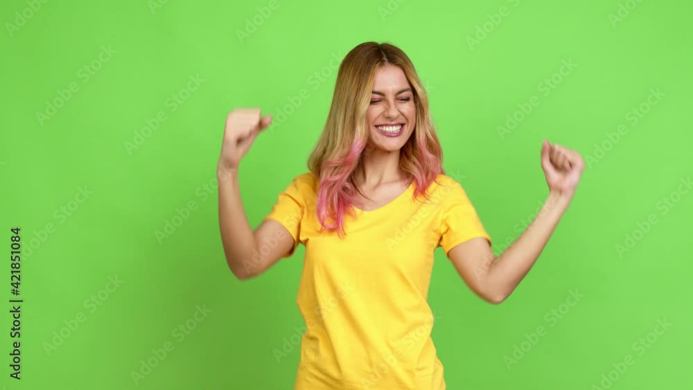 Young blonde woman celebrating a victory and surprised to be successful over isolated background on green screen chroma key Young blonde woman celebrating a victory and surprised to be successful over isolated background on green screen chroma key