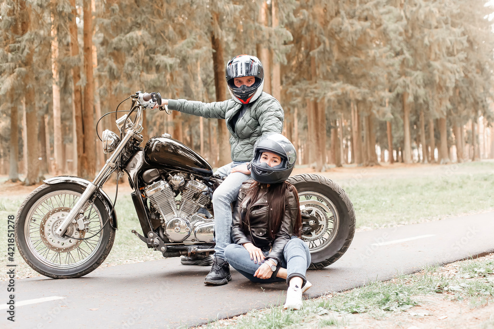 Fototapeta premium guy with a girl in the park on a motorcycle