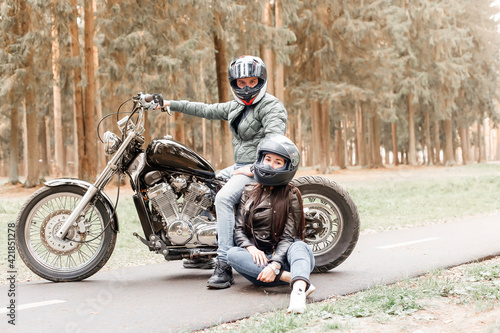 guy with a girl in the park on a motorcycle