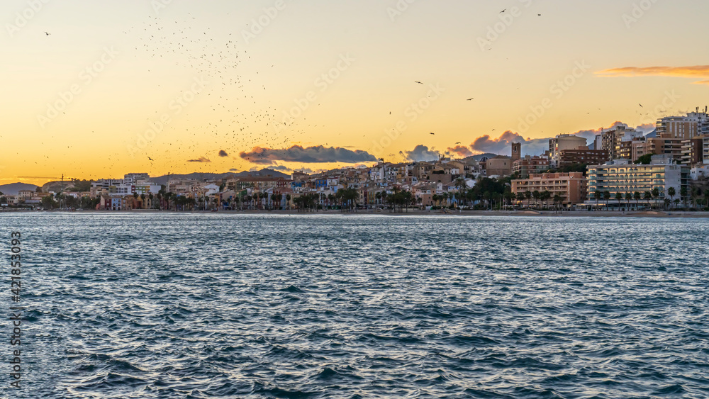 View of the town of Villajoyosa from its fishing port at sunset.