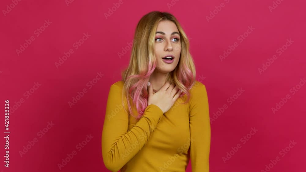 Young blonde woman gaping because have just surprised with a gift over isolated background Young blonde woman gaping because have just surprised with a gift over isolated background