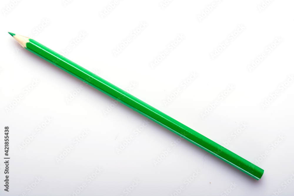Various colored wooden pencil crayons placed in a row in front of a white isolated background Various colored wooden pencil crayons placed in a row in front of a white isolated background