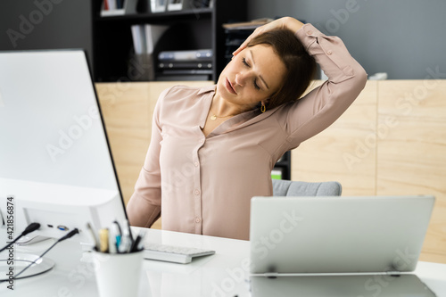 Woman Stretching At Office Desk