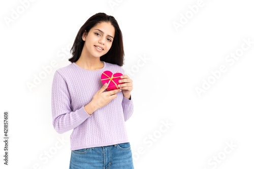 Latin woman with heart shaped gift box in hands on white background