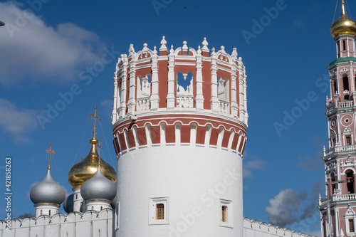 Openwork balaya with a red defensive tower against the background of the domes of the Smolensk Cathedral, Novodevichy Convent, spring 2021 photo