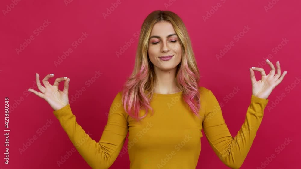 Young blonde woman in zen position over isolated background Young blonde woman in zen position over isolated background