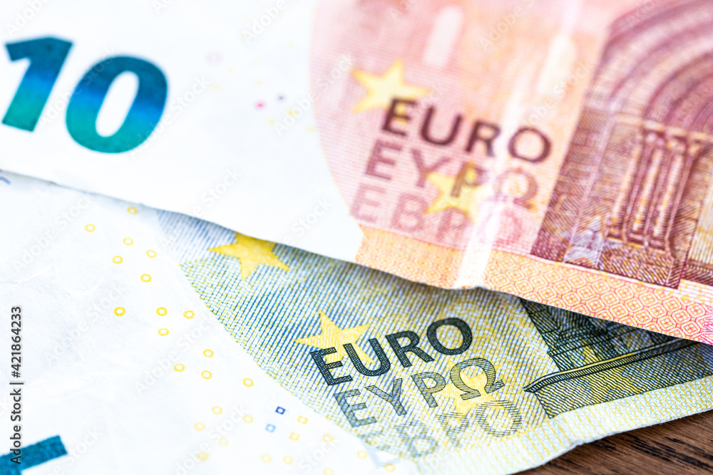Euro money cash, 10 and 5 euro banknotes as a backdrop for topics such