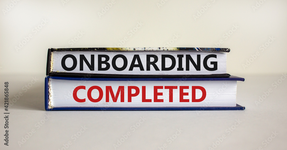 Onboarding completed symbol. Books with words 'Onboarding completed'. Beautiful white background. Business, onboarding completed concept, copy space.