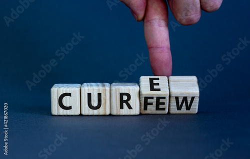 Curfew and cure symbol. Businessman turns cubes and changes the word 'curfew' to 'cure'. Beautiful grey background. Business, curfew and cure concept. Copy space.