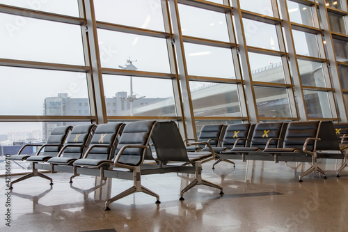 Airport, departure area. Labeled waiting chairs for social distancing during a pandemic. photo
