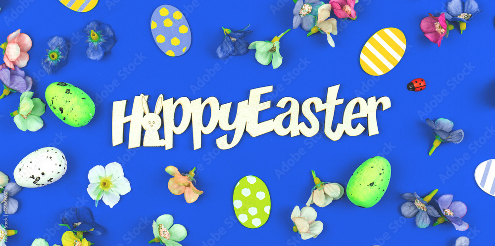 Happy Easter greeting card banner with Easter decoration, painted eggs and spring flowers